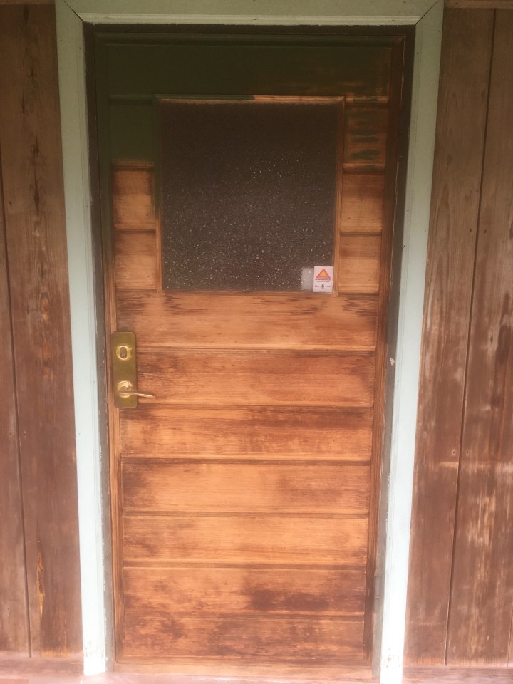 Ytterdörr från 1958. Lackad furu som slitits rätt hårt genom åren. Test med grön kulör upptill.